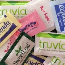 Multiple sweetener and sugar packets.