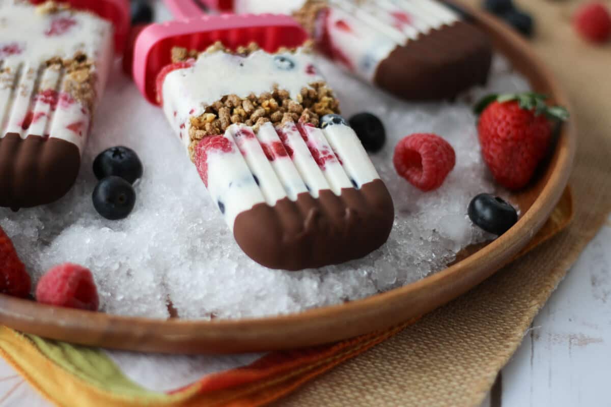 A close up of healthy banana popsicle recipe on a plate of ice.