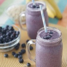 Two glasses of blueberry smoothies.