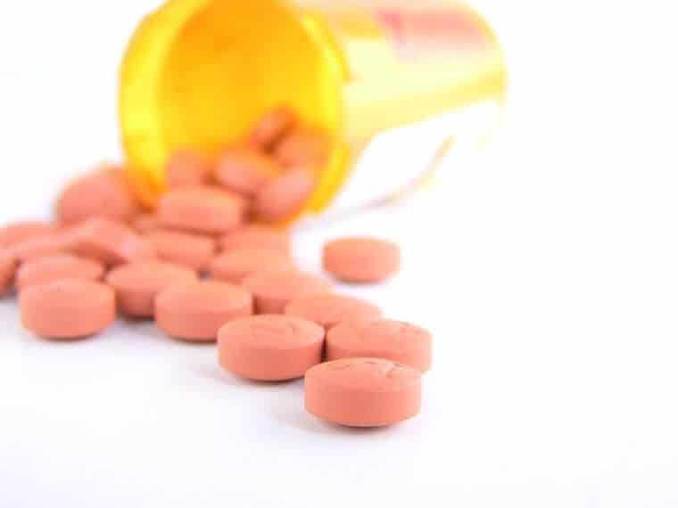 Pills coming out of a bottle.
