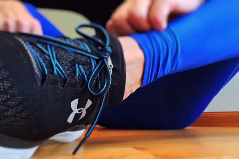 Close up of a running shoe on a person sitting. 