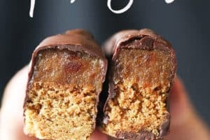 A hand holding up two vegan Twix bars.