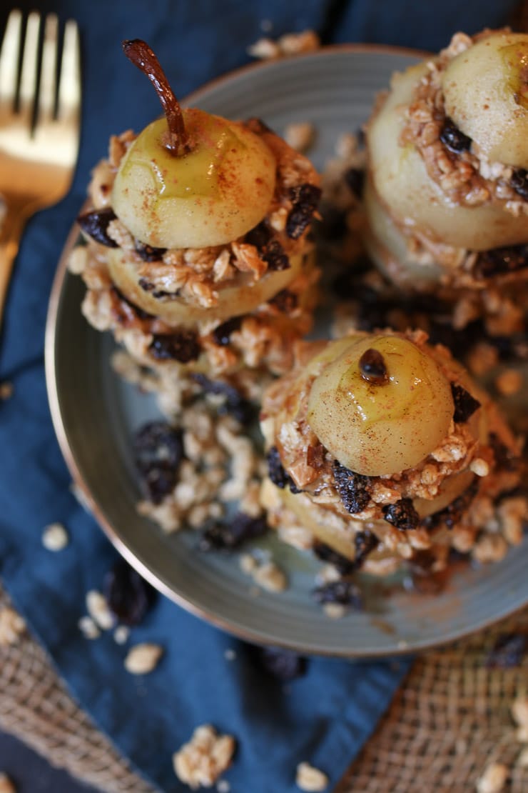 birds eye view of vegan and gluten free granola layered poached pears on a grey plate