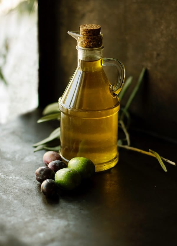 Jug of olive oil consumed as a postpartum hair loss help.