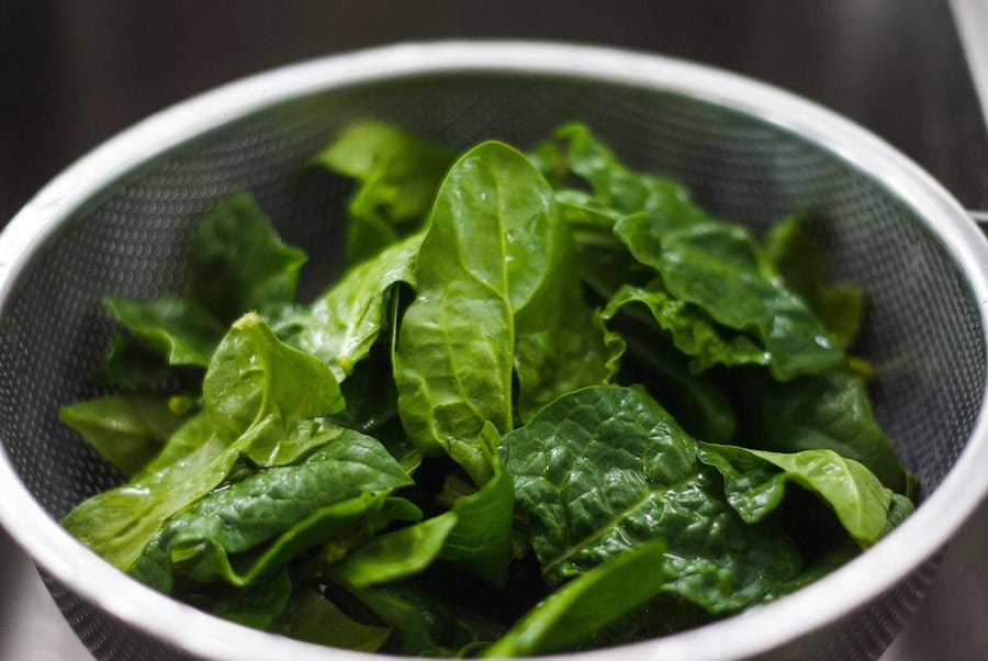 leafy greens in a large silver bowl