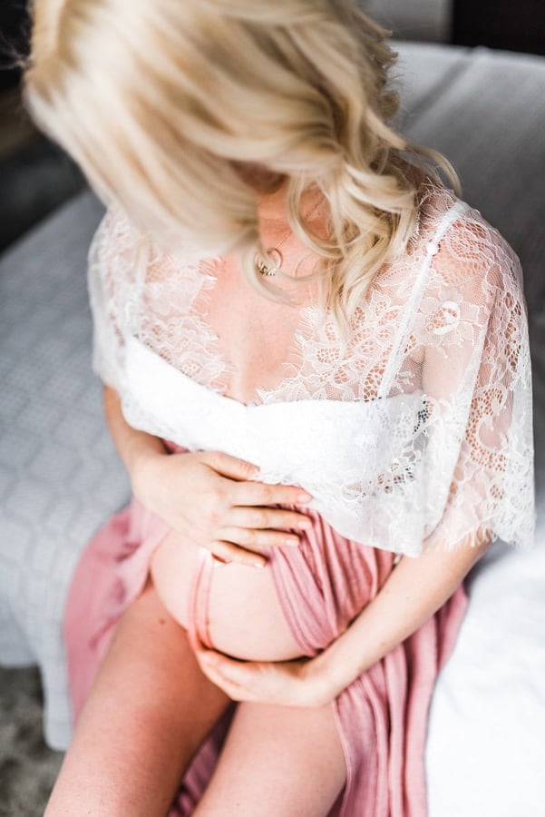 Women holding her pregnant belly. 