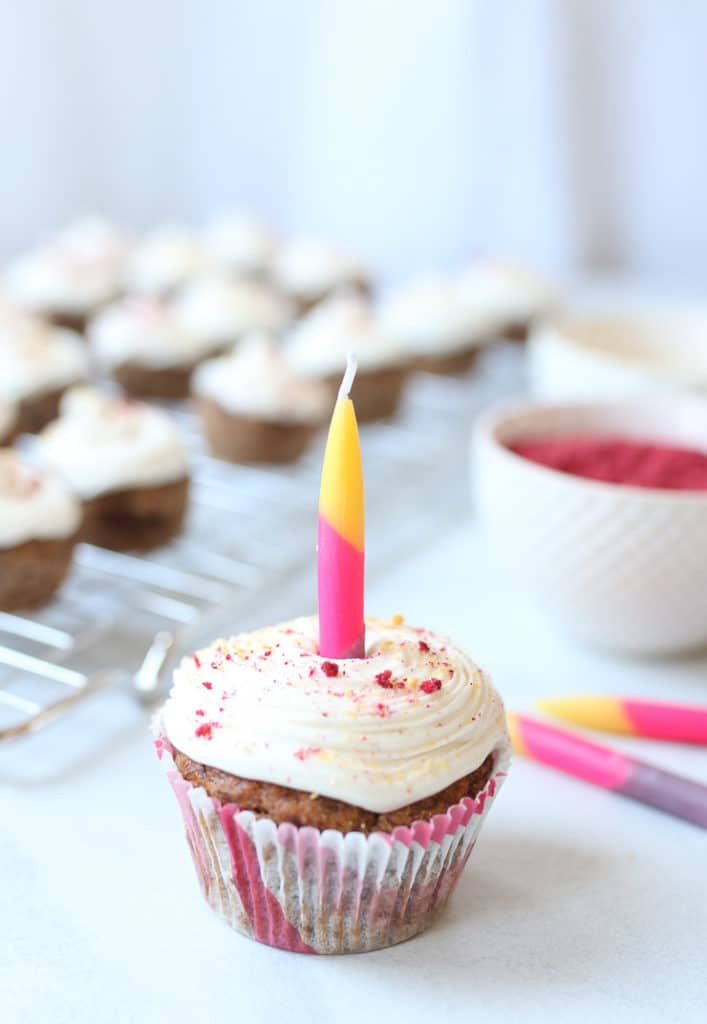 Mini vegan cupcake with one lit candle in the middle.