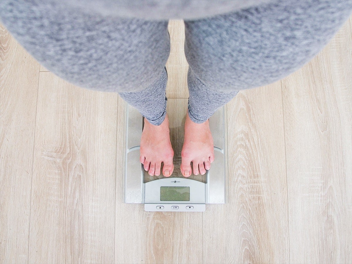 Women standing on a scale.