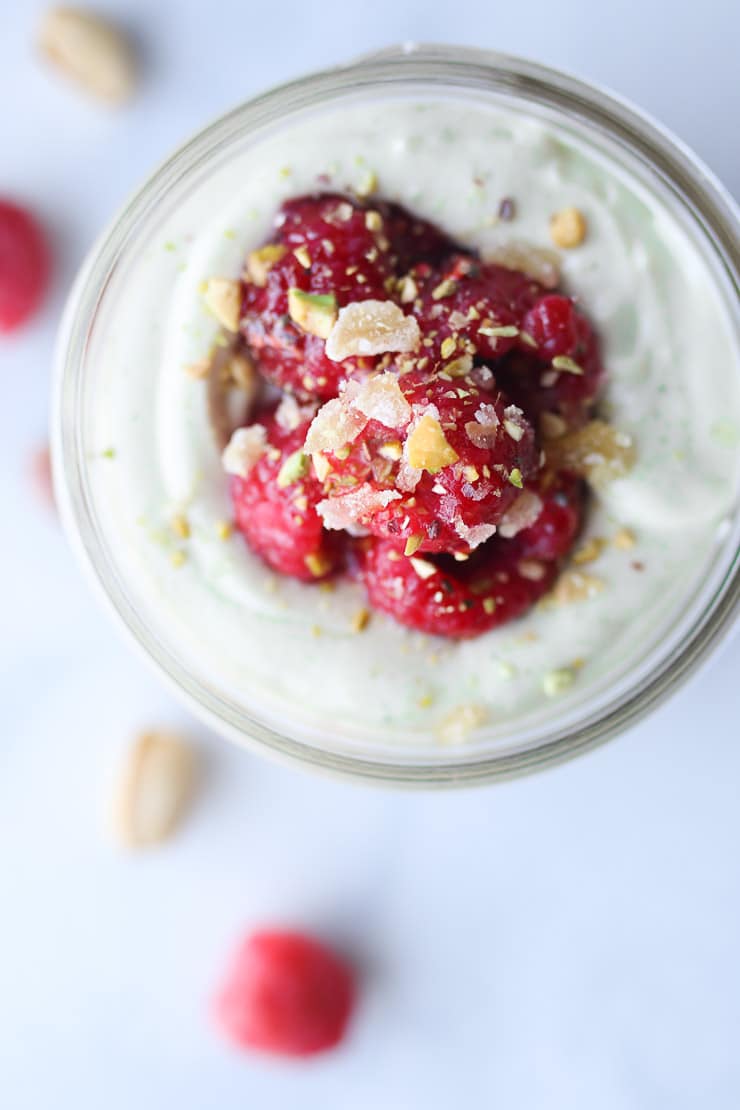 Birds eye view of matcha cheesecake recipe topped with berries.
