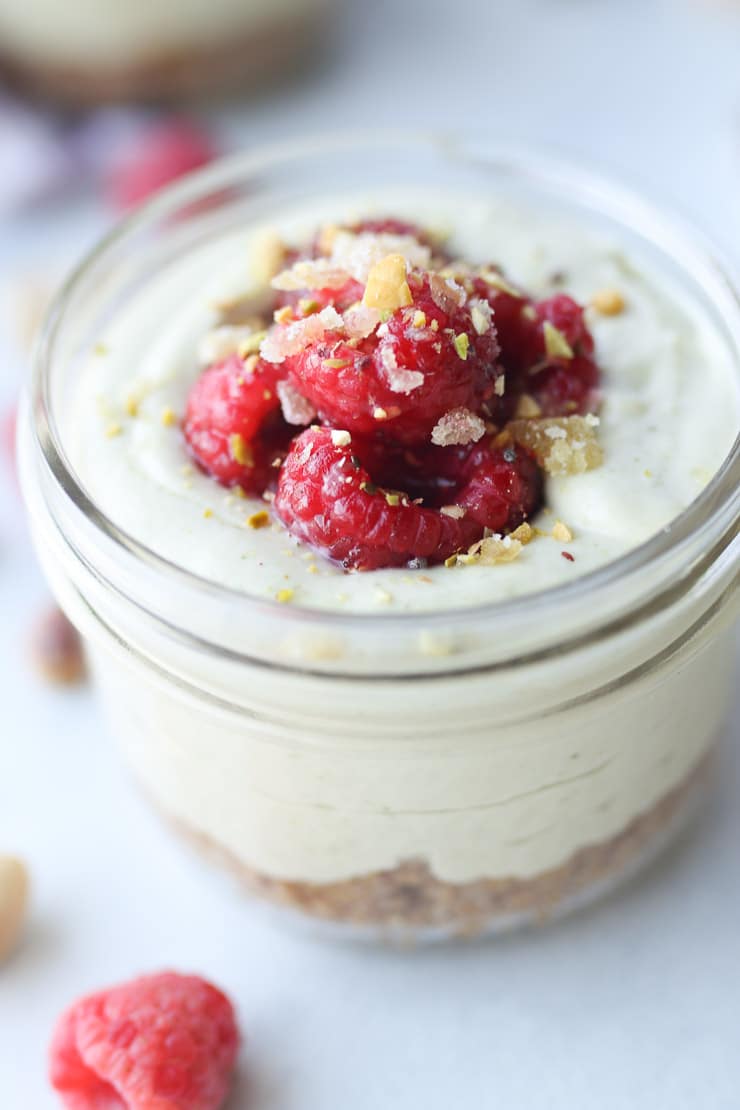 Close up of matcha cheesecake recipe parfait in a glass mason jar.