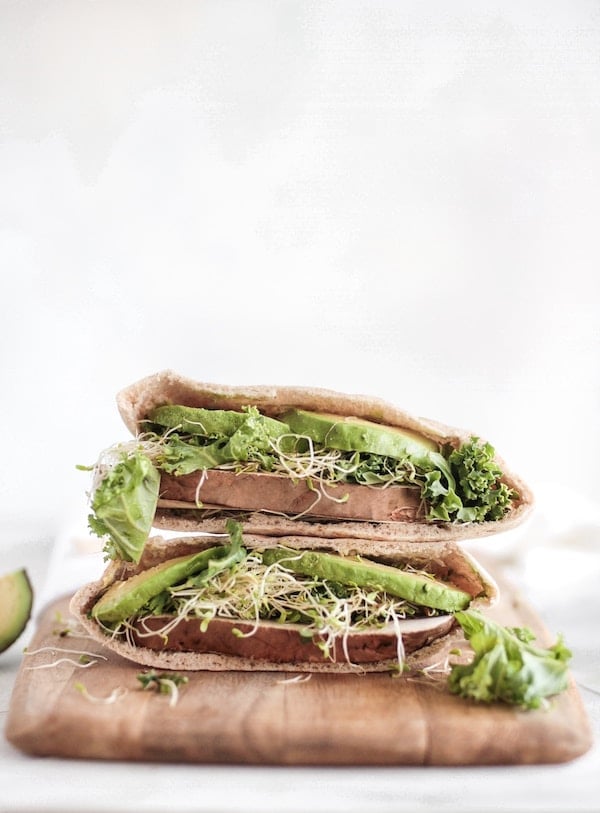 Two pita sandwiches packed with veggies.