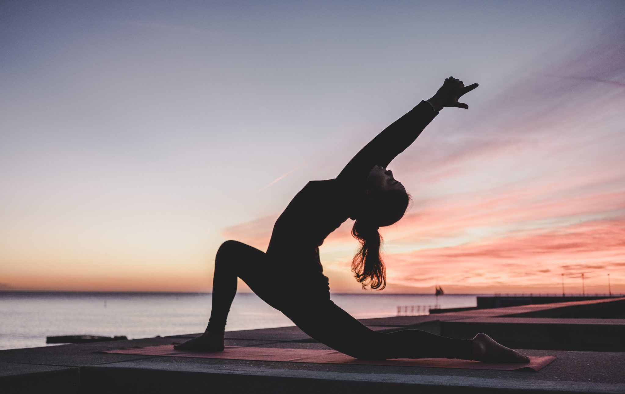 woman practicing yoga to relieve discomfort from vegan diet and bloating
