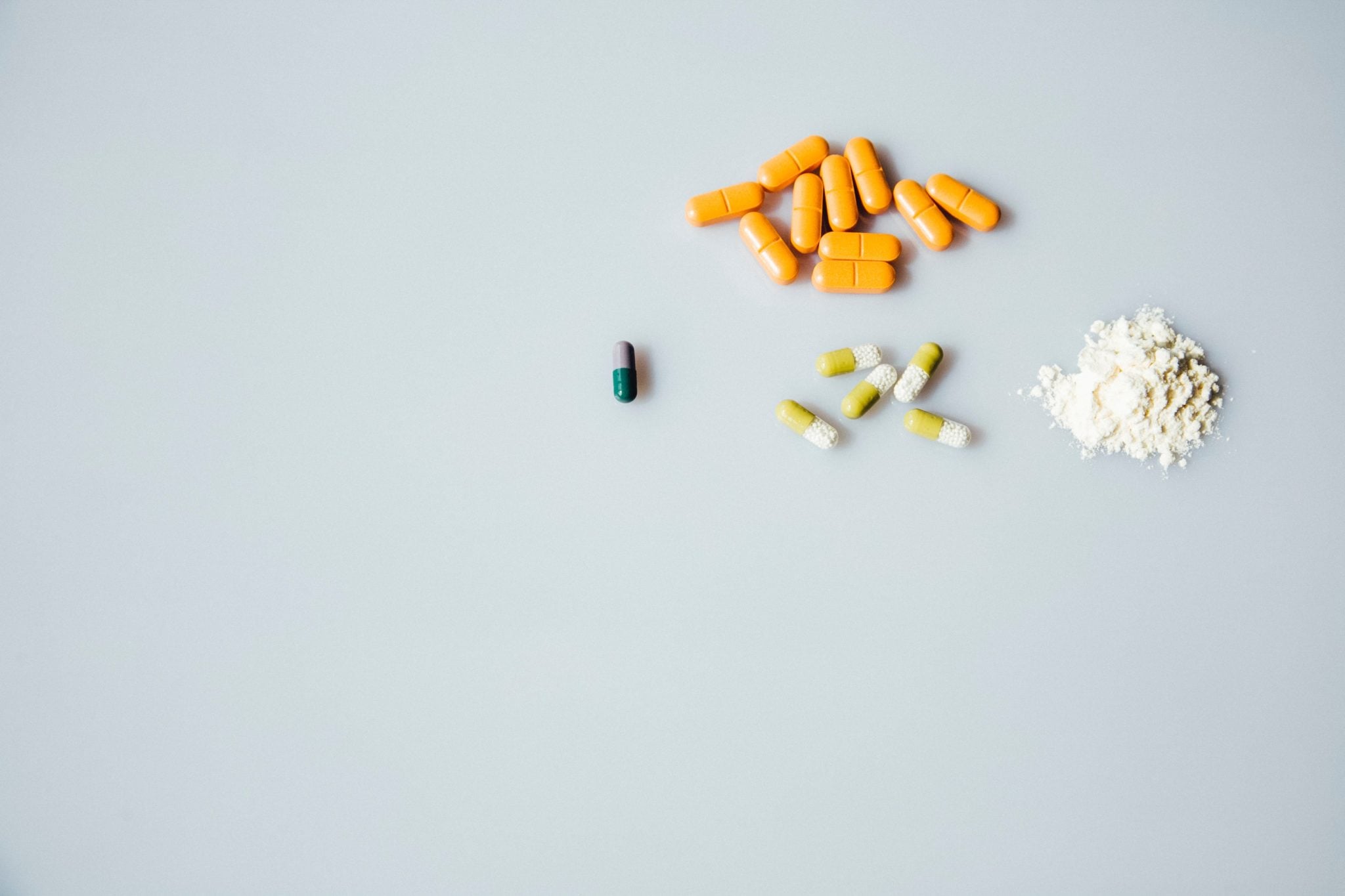 birds eye view of supplements for thin uterine lining on a grey backdrop
