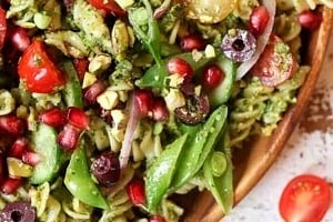 Pinterest graphic of bowl of pesto pasta salad with text overlay "pesto pasta salad."