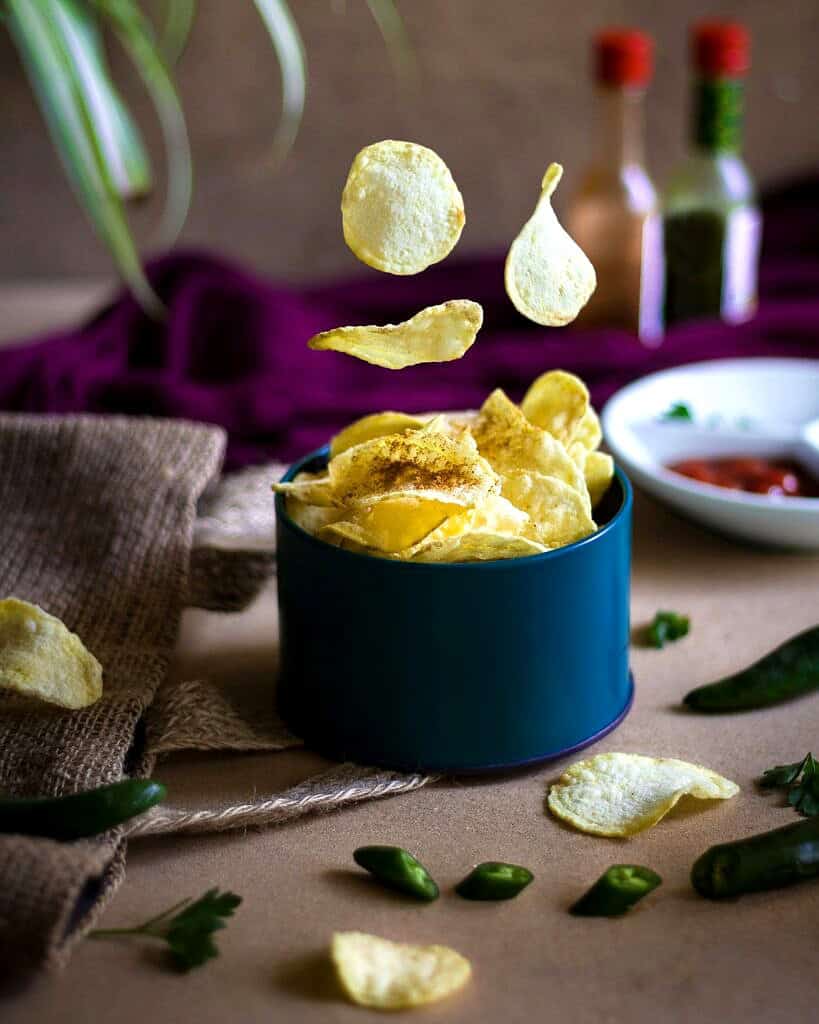 Chips falling into a blue bowl