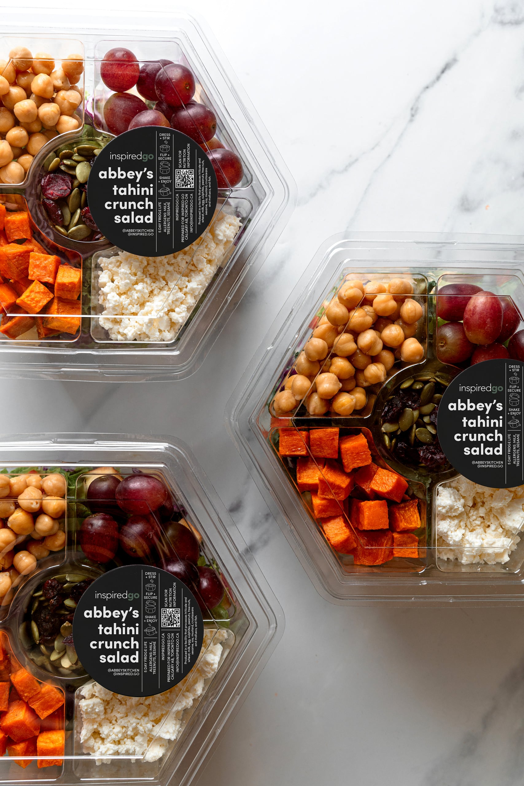 Three containers with Inspired Go tahini crunch salad.