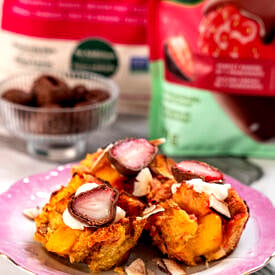 Close up of three tropical french toast muffins, topped with chocolate covered strawberries.